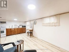 Toronto (Oakwood Village) apartment for rent - A living room with a sofa, a table, and a kitchen area in the background.