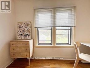 Toronto (Oakwood Village) apartment for rent - A room with a dresser and a window with blinds.