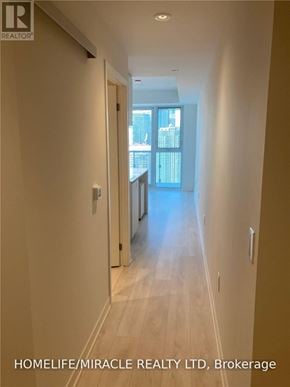 Toronto (Waterfront Communities) condo for rent - A hallway with a door leading to a balcony.