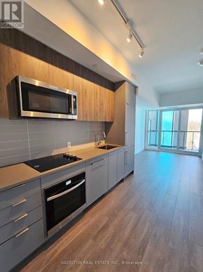 Toronto (Willowdale East) condo for rent - A modern kitchen with a microwave above the stove.