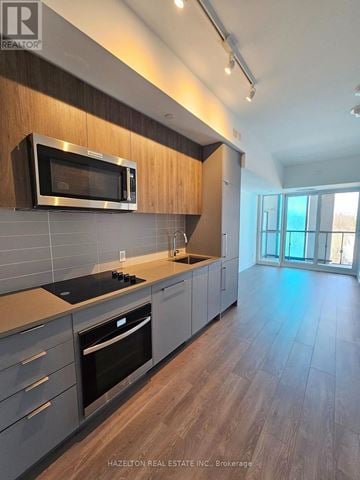Toronto (Willowdale East) condo for rent - A modern kitchen with a microwave above the stove.