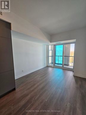 Toronto (Willowdale East) condo for rent - A room with wood flooring and a large window.