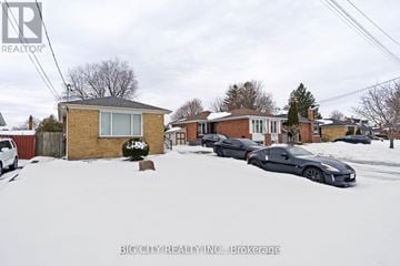 Toronto (Wexford-Maryvale) apartment for rent - A black car is parked in front of a house in the snow.