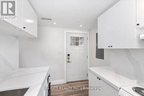 Toronto (Wexford-Maryvale) apartment for rent - A white kitchen with a door and a window.