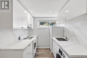Toronto (Wexford-Maryvale) apartment for rent - A white kitchen with a window and a sink.