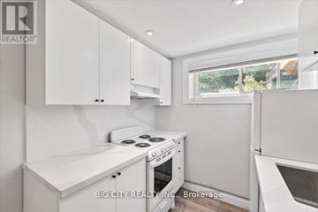 Toronto (Wexford-Maryvale) apartment for rent - A white kitchen with a stove and cabinets.