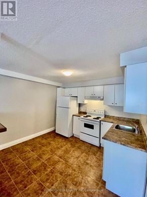 Markham (Old Markham Village) multi-family for rent - A kitchen with white appliances and brown tiled flooring.