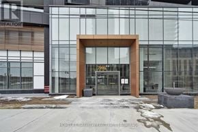 Vaughan (Concord) condo for rent - The entrance to a building with a glass facade and a brown archway.