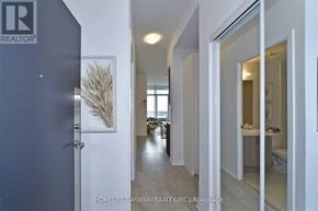 Vaughan (Concord) condo for rent - A hallway with a door on the left and a bathroom on the right.