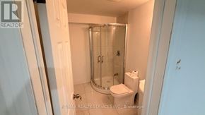 Vaughan (Vellore Village) apartment for rent - A small white bathroom with a toilet, a sink and a shower.