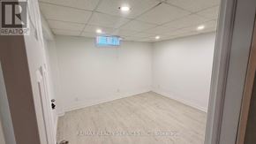Vaughan (Vellore Village) apartment for rent - A room with white walls and a wooden floor is shown.