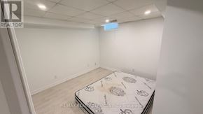 Vaughan (Vellore Village) apartment for rent - A bedroom with a bed in the middle and a sign on the wall.