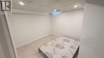 Vaughan (Vellore Village) apartment for rent - A bedroom with a bed in the middle and a sign on the wall.