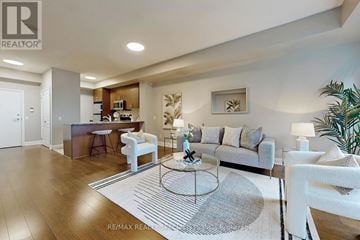 Mississauga (Port Credit) condo for rent - A modern living room with a white sofa set and a coffee table.