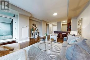 Mississauga (Port Credit) condo for rent - A living room with a glass table and a white couch.