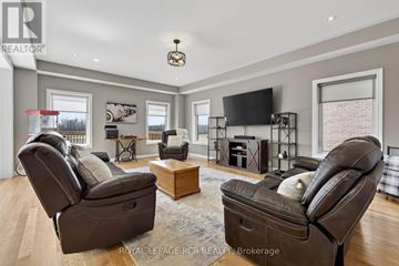 Southgate apartment for rent - A living room with brown leather chairs and a flat screen TV mounted on the wall.