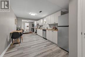 Southgate apartment for rent - A modern kitchen with white appliances and a dining table with chairs.