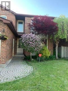 Vaughan (Crestwood-Springfarm-Yorkhill) apartment for rent - A house with a red flowering tree in front.
