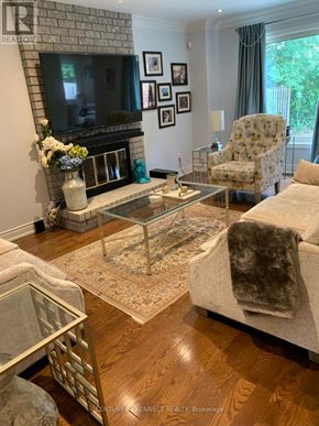 Vaughan (Crestwood-Springfarm-Yorkhill) apartment for rent - A living room with a fireplace, a couch, and a coffee table.