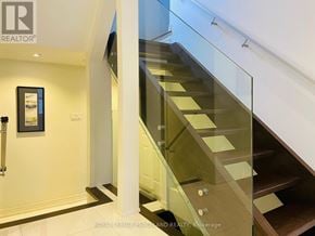 Richmond Hill (Westbrook) apartment for rent - A glass staircase with a white wall and a picture frame on the wall.