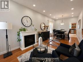 Kitchener apartment for rent - A living room with a fireplace and a clock on the wall.