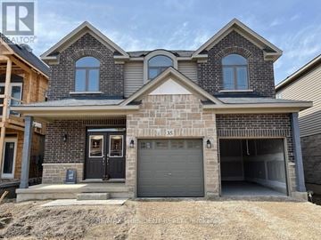 Brantford apartment for rent - A house with a garage and a driveway in front.