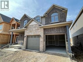 Brantford apartment for rent - A house under construction with a grey garage door.