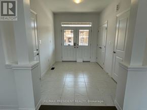 Brantford apartment for rent - A hallway with white walls and a tiled floor.
