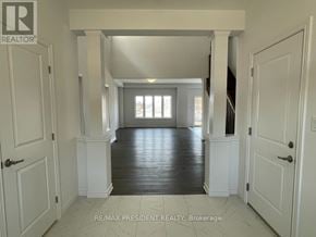 Brantford apartment for rent - A spacious hallway with white doors and a wooden floor.