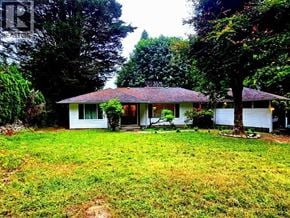 West Vancouver apartment for rent - A house with a red roof is surrounded by trees.