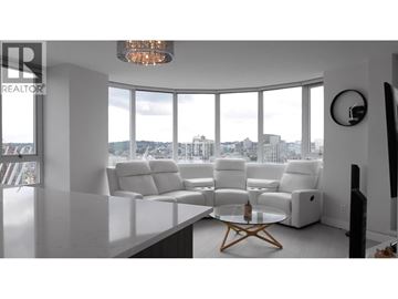 Vancouver apartment for rent - A living room with white furniture and a large window overlooking the city.