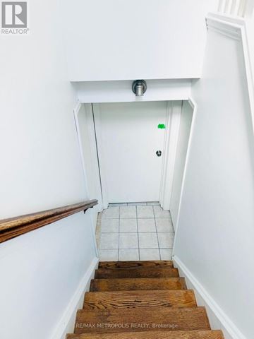 Toronto (Glenfield-Jane Heights) apartment for rent - A stairway with a white door at the top.