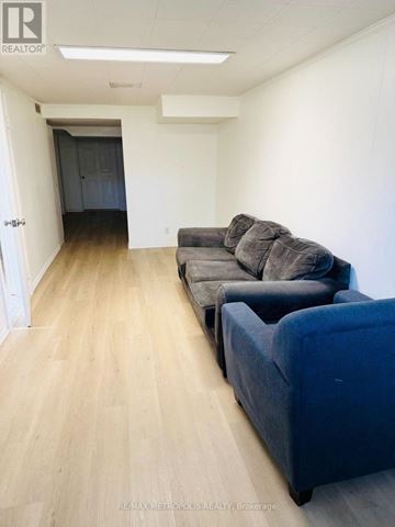 Toronto (Glenfield-Jane Heights) apartment for rent - A living room with a grey couch and a blue ottoman.