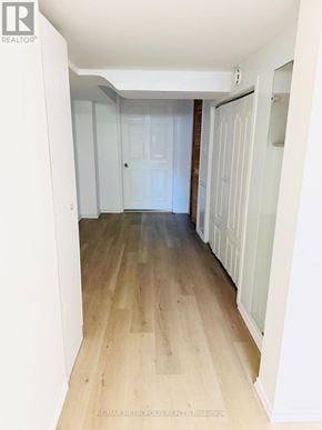 Toronto (Glenfield-Jane Heights) apartment for rent - A hallway with wooden floors and white walls.
