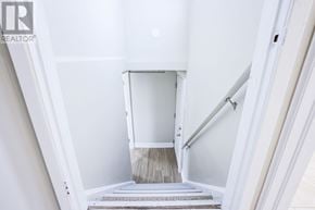 Mississauga (Malton) apartment for rent - A stairway with a white railing and steps leading to a landing.