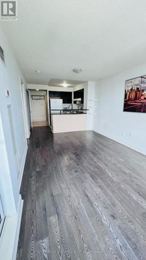 Toronto (Bendale) condo for rent - A room with a wooden floor and a painting on the wall.