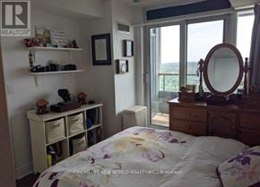 Toronto (Bendale) condo for rent - A bedroom with a bed, dresser, and a window with a view.