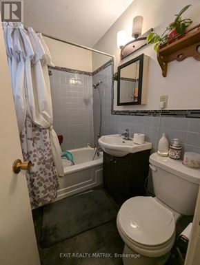 Edwardsburgh/Cardinal multi-family for rent - A bathroom with a toilet, sink, and bathtub.