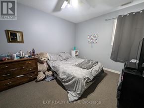 Edwardsburgh/Cardinal multi-family for rent - A bedroom with a bed, dresser, and a teddy bear.
