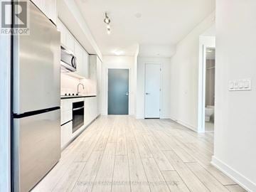 Toronto (Newtonbrook West) condo for rent - A kitchen with a refrigerator, oven, and microwave.