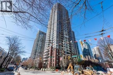 Vancouver apartment for rent - A construction site is in the foreground of a city street with a large building in the background.