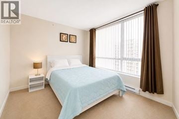 Vancouver apartment for rent - A bedroom with a bed, nightstand, and window.