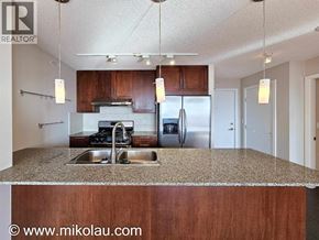 Burnaby apartment for rent - A kitchen with a sink, stove, and refrigerator.