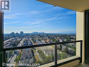 Burnaby apartment for rent - A view from a balcony overlooking a cityscape.