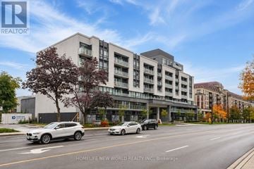 Toronto (Bayview Village) condo for rent - A modern apartment building with cars parked in front.