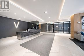 Toronto (Bayview Village) condo for rent - A modern office lobby with a reception desk and a large area rug.