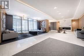 Toronto (Bayview Village) condo for rent - A spacious living room with a fireplace and a large rug.