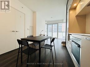 Toronto (Bay Street Corridor) condo for rent - A dining area with a table and chairs in a kitchen.