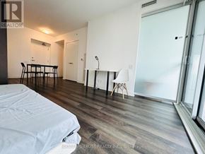 Toronto (Bay Street Corridor) condo for rent - A bedroom with a bed, desk, and chair.