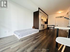 Toronto (Bay Street Corridor) condo for rent - A bedroom with a bed, desk, and chair.